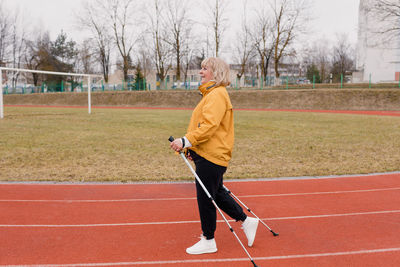 Side view of woman standing on field