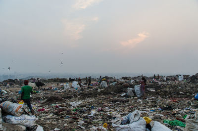 People on beach against sky