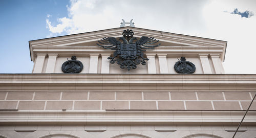 Low angle view of statue on building against sky