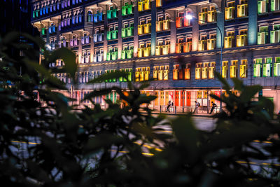 Rainbow windows of a building in city at night