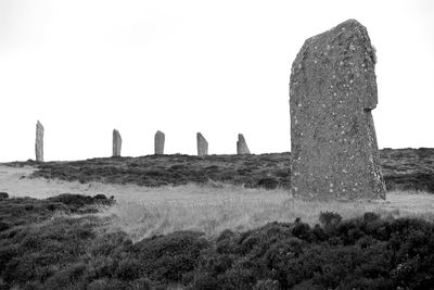 Low angle view of old ruin on field against sky