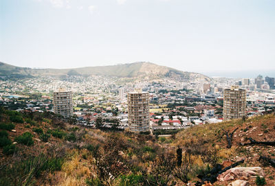 Buildings in city against clear sky