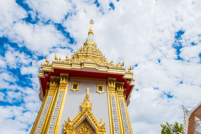 Low angle view of temple building against cloudy sky