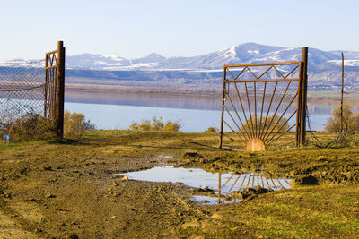 Iron gate and mountain lake view