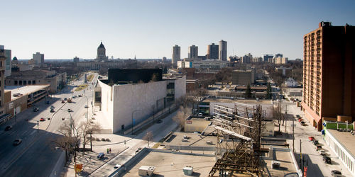 High angle view of city buildings against clear sky