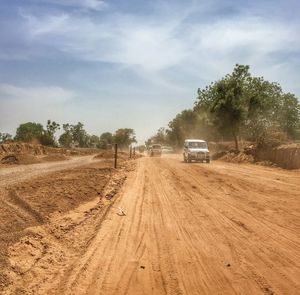 Vehicles on dirt road