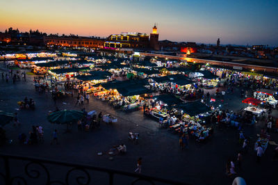High angle view of market in city at dusk