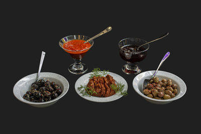 High angle view of fruits in glass on table against black background