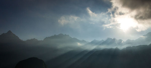 Scenic view of silhouette mountains against sky