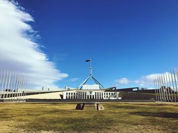 Built structure on field against blue sky