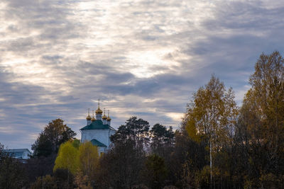 Panoramic view of trees and buildings against sky