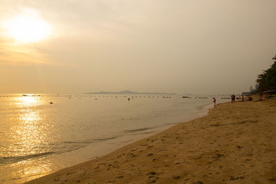 Scenic view of beach against sky during sunset