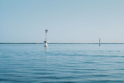 Sailboat sailing in sea against clear sky