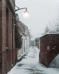 Street amidst buildings in city during winter