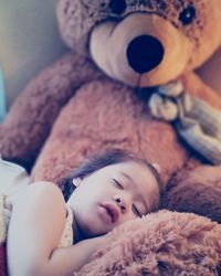 High angle view of baby sleeping on bed