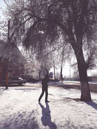 Silhouette man by trees against sky