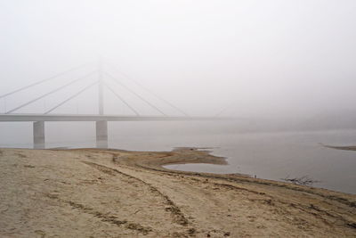 Bridge over sea against sky
