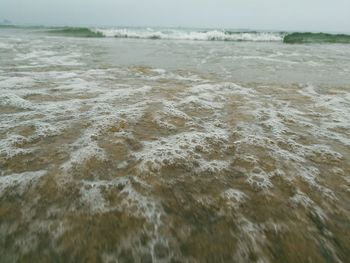 Close-up of waves in sea against sky