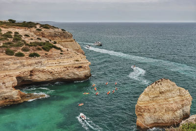 High angle view of rock formation in sea against sky