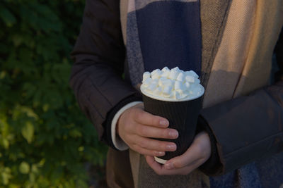 Midsection of person holding ice cream