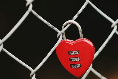 Close-up of padlock hanging on metal