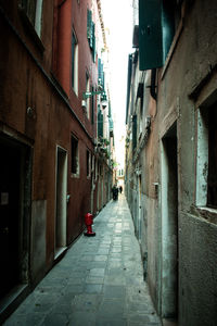 Narrow alley amidst buildings in city