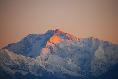 Scenic view of snowcapped mountains against clear sky