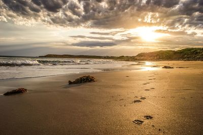 Scenic view of beach against sky during sunset