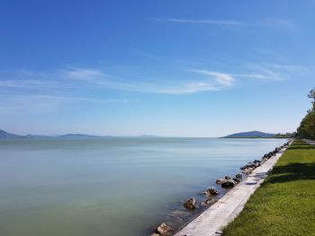 Scenic view of lake against blue sky