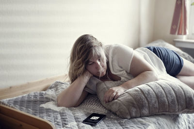 Woman relaxing on bed at home