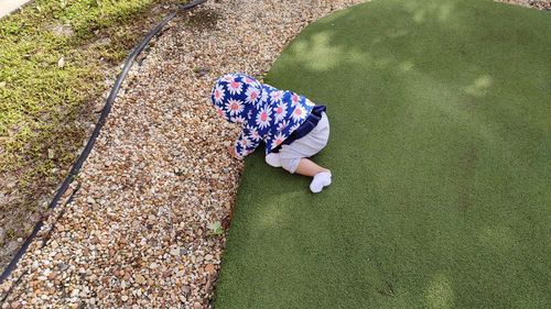 High angle view of baby playing on land