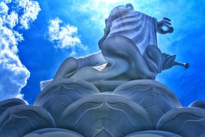 Low angle view of statue against blue sky