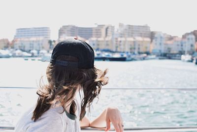 Close-up of young woman against sea