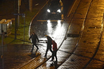 High angle view of people walking on wet floor