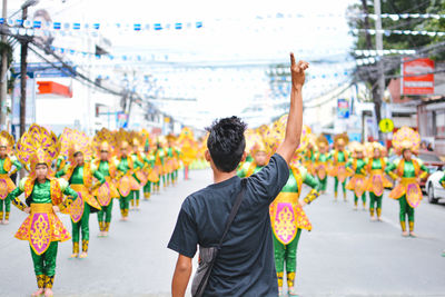 Rear view of man holding hands