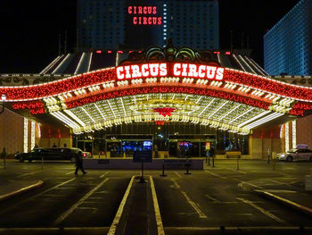 View of ferris wheel in city at night