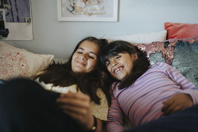 Sisters bonding over surfing internet on tablet together