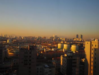 High angle view of city buildings against clear sky