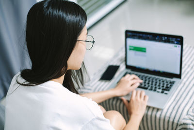 Portrait of woman using laptop