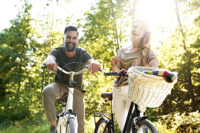 Portrait of smiling couple against trees