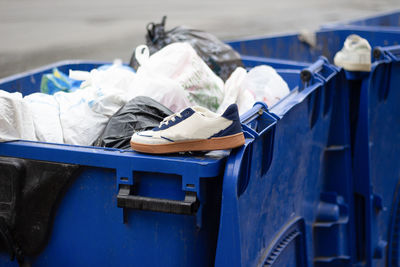 Sports sneakers in a trash container