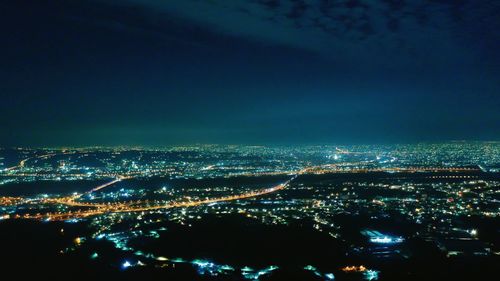 High angle view of illuminated buildings in city at night