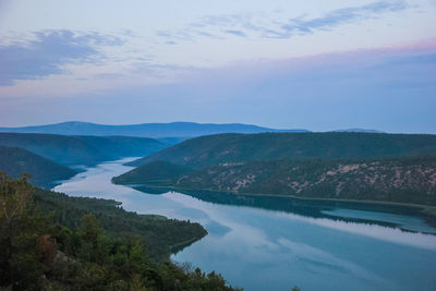 Scenic view of lake and mountains against sky