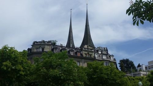 Low angle view of building against cloudy sky