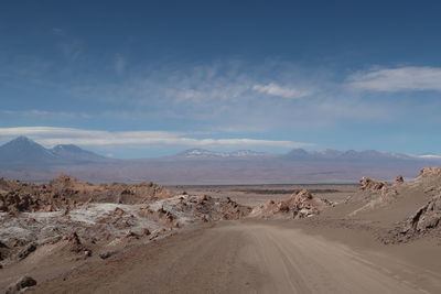 Panoramic view of road on desert against sky