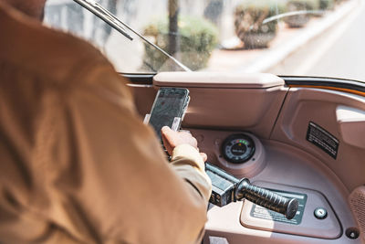 Midsection of man using mobile phone