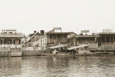 Boats in river with buildings in background