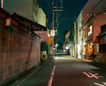 Road passing through illuminated city