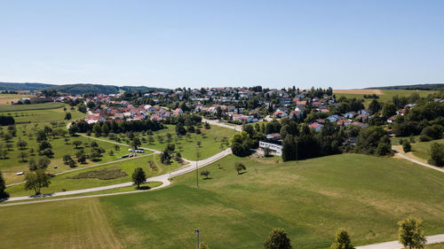 High angle view of trees and buildings against clear sky