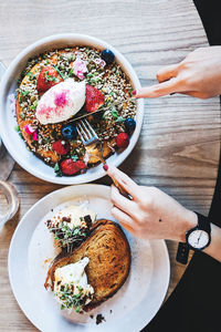 Directly above shot of hands over food on table